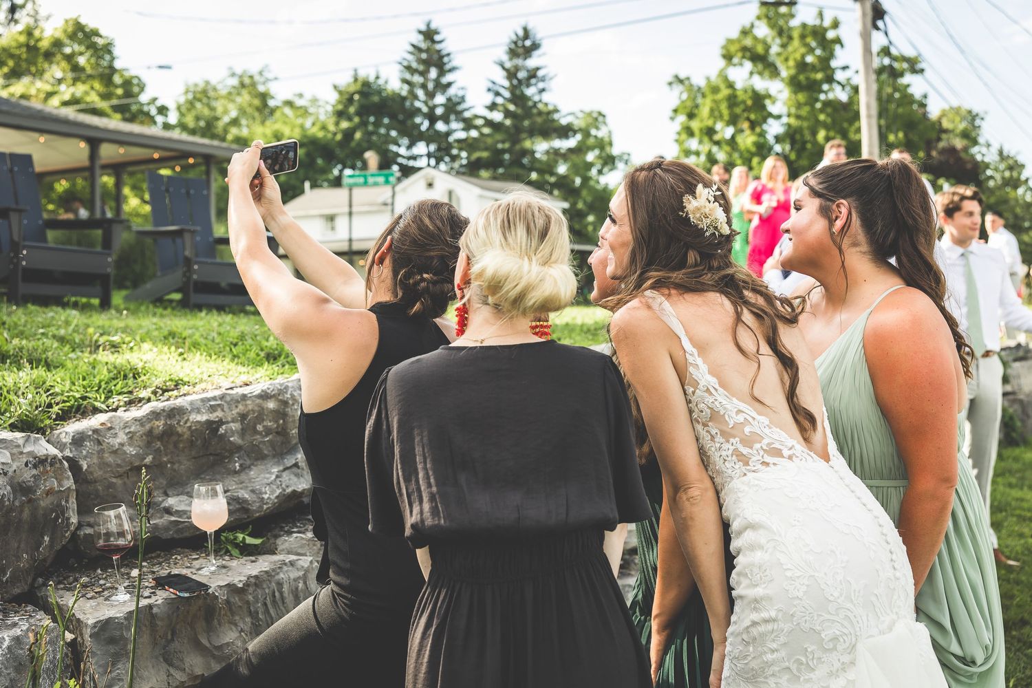 Wedding guests mingling and celebrating outdoors during a summer reception.