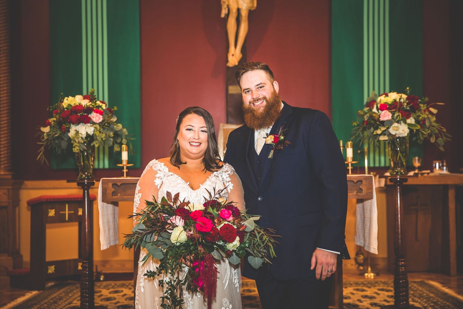 Wedding ceremony in a church with green columns and red walls.