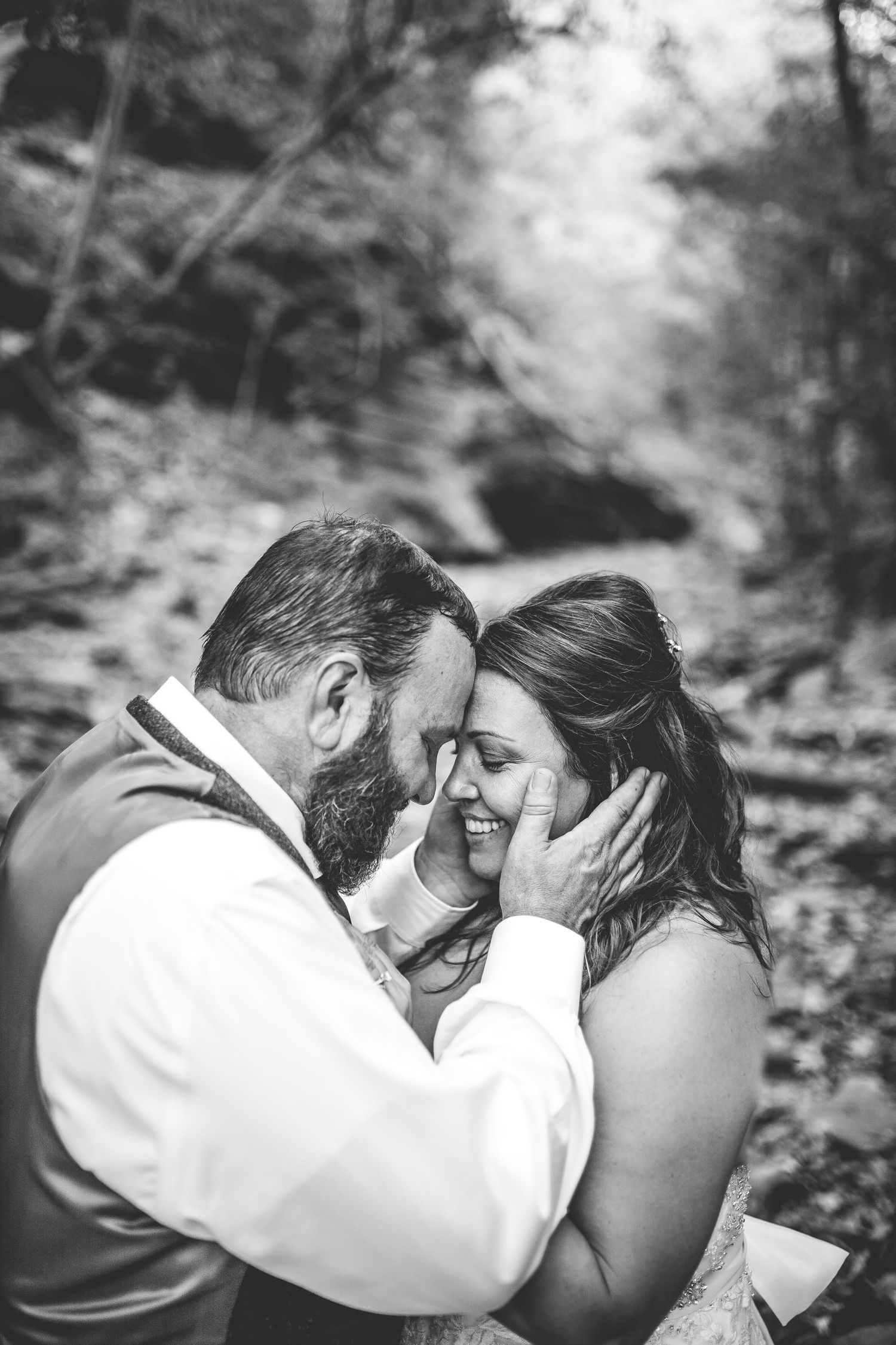 Intimate black and white romantic moment captured in a natural setting.