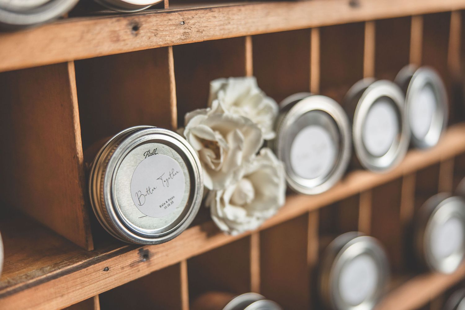 Wooden shelving unit storing mason jars and preserved items in organized rows.