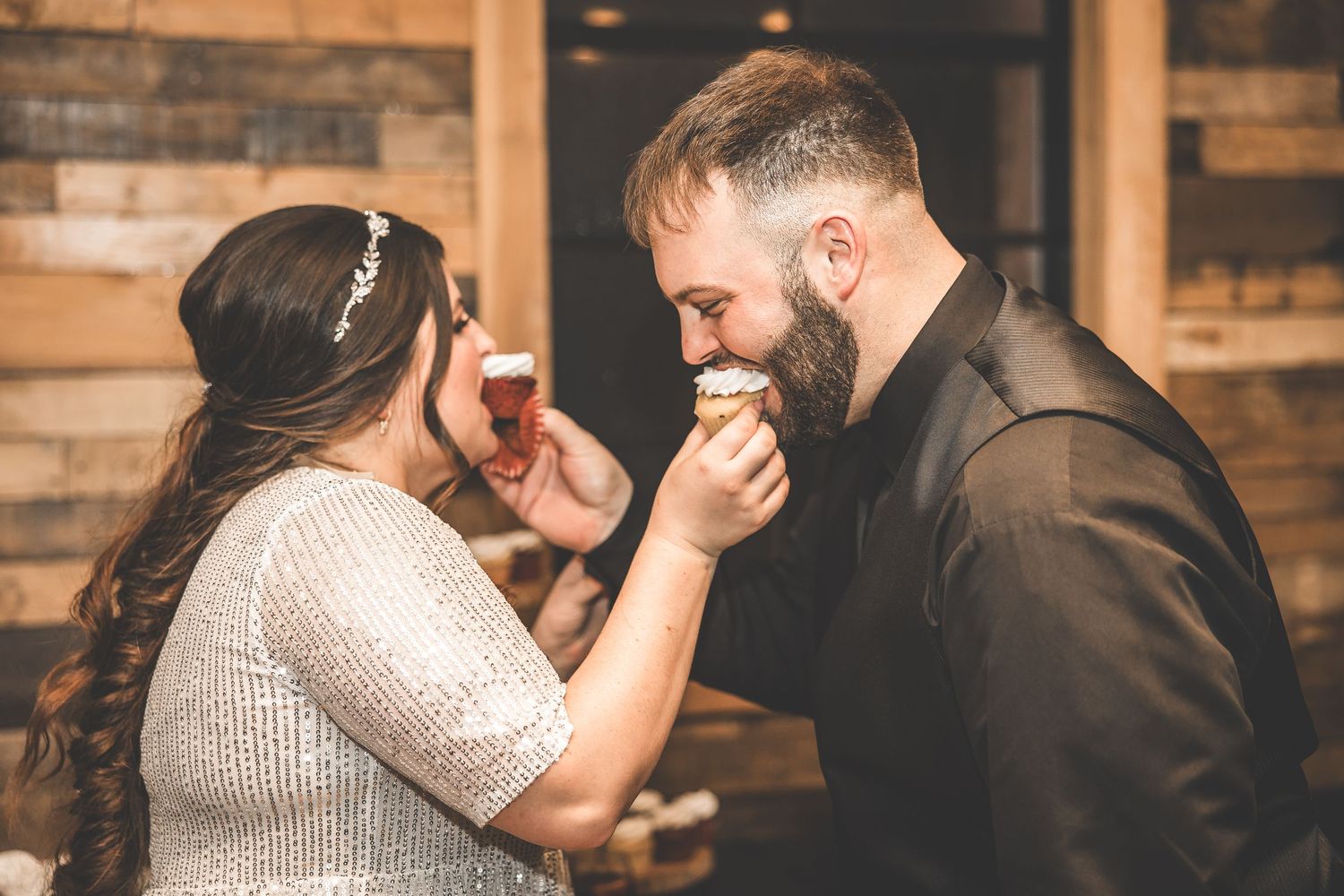 Couples share intimate dance moments during a wedding reception in a rustic venue.