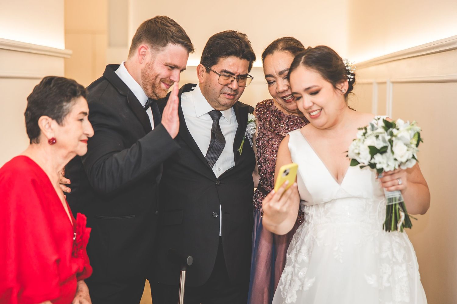 Wedding party members share emotional moments and hugs during the celebration.