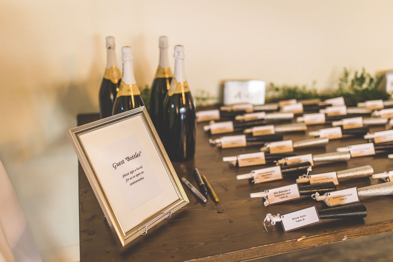 Wedding place cards arranged on dark wooden surface with soft focus.