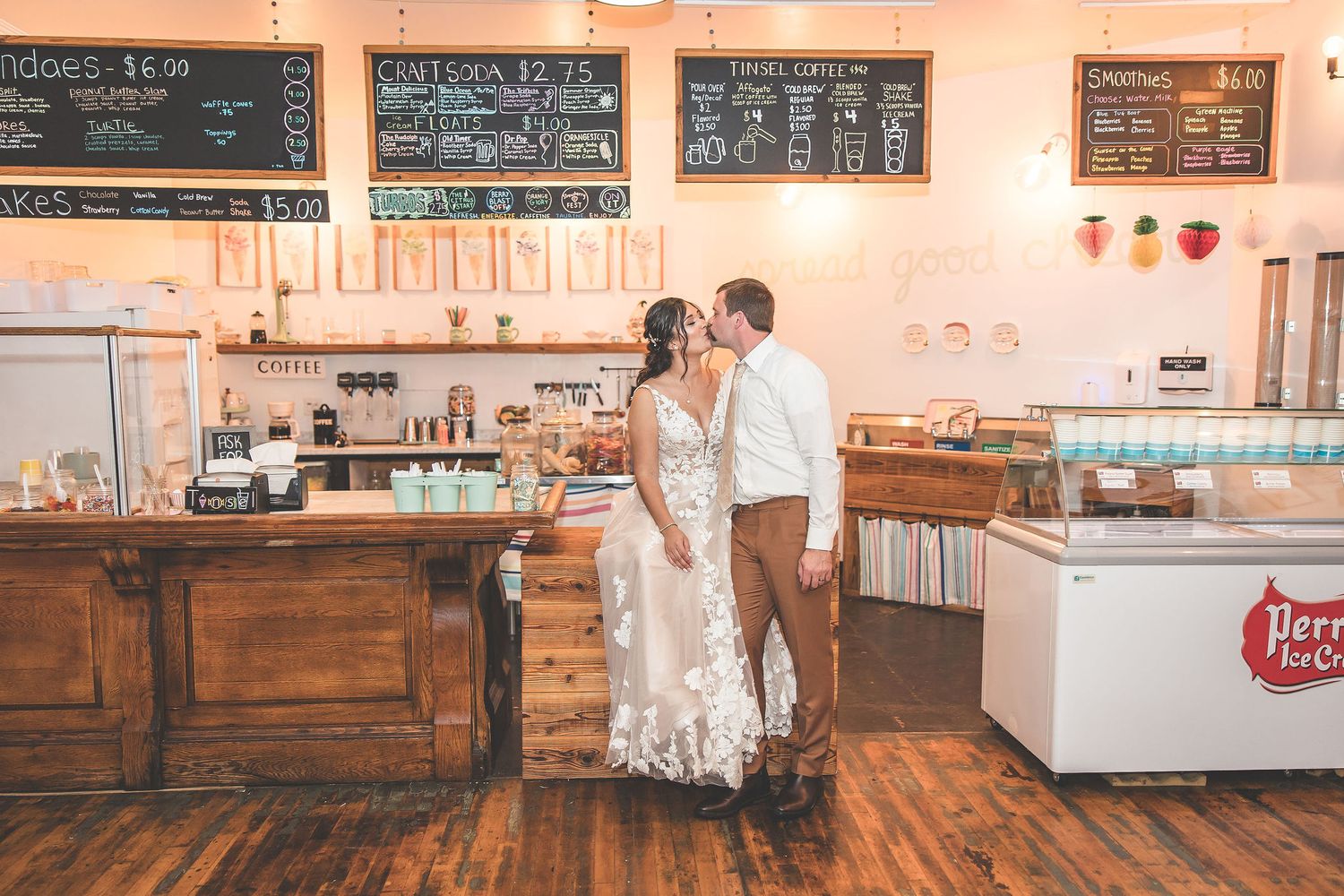 Rustic ice cream parlor interior with wooden counters and chalkboard menus on the wall.