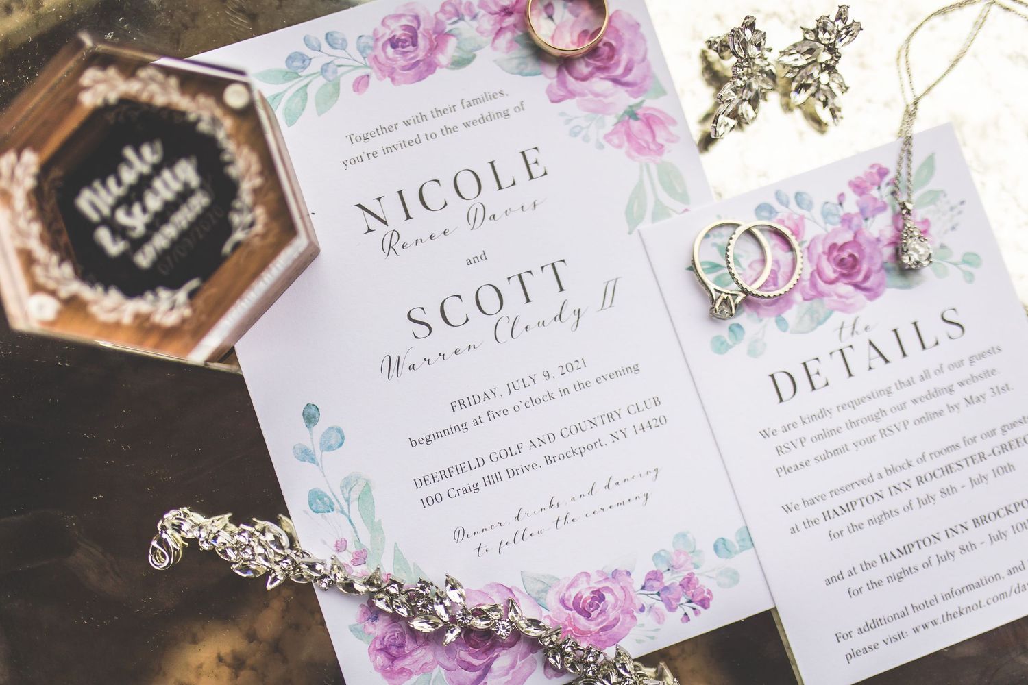 Floral wedding invitation suite with watercolor roses and elegant typography.