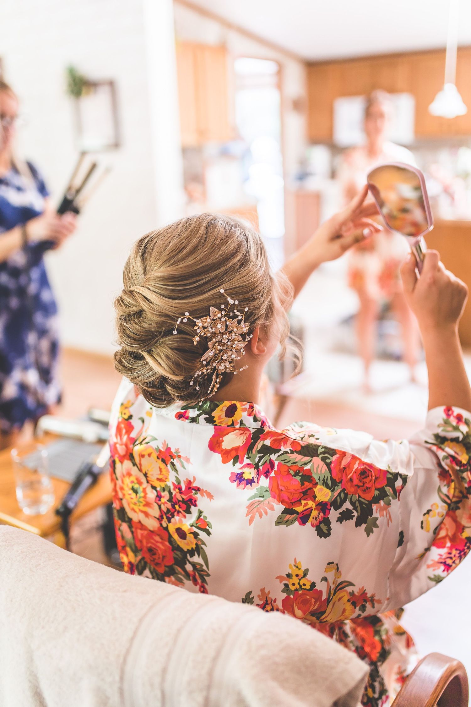 Close up of elegant bridal hairstyle with floral accessories and robe.