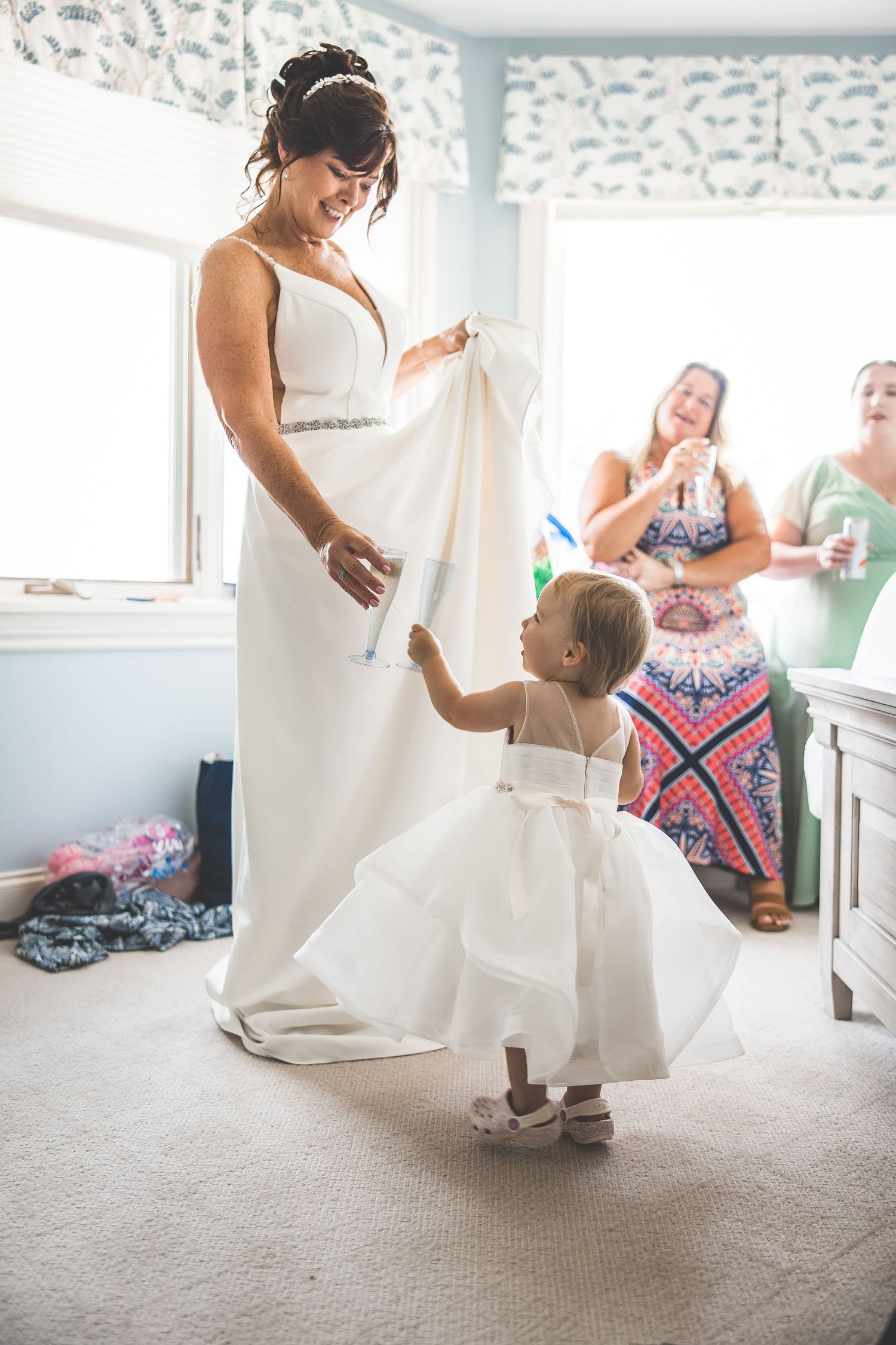Wedding dress details and preparations captured in a bright indoor setting.