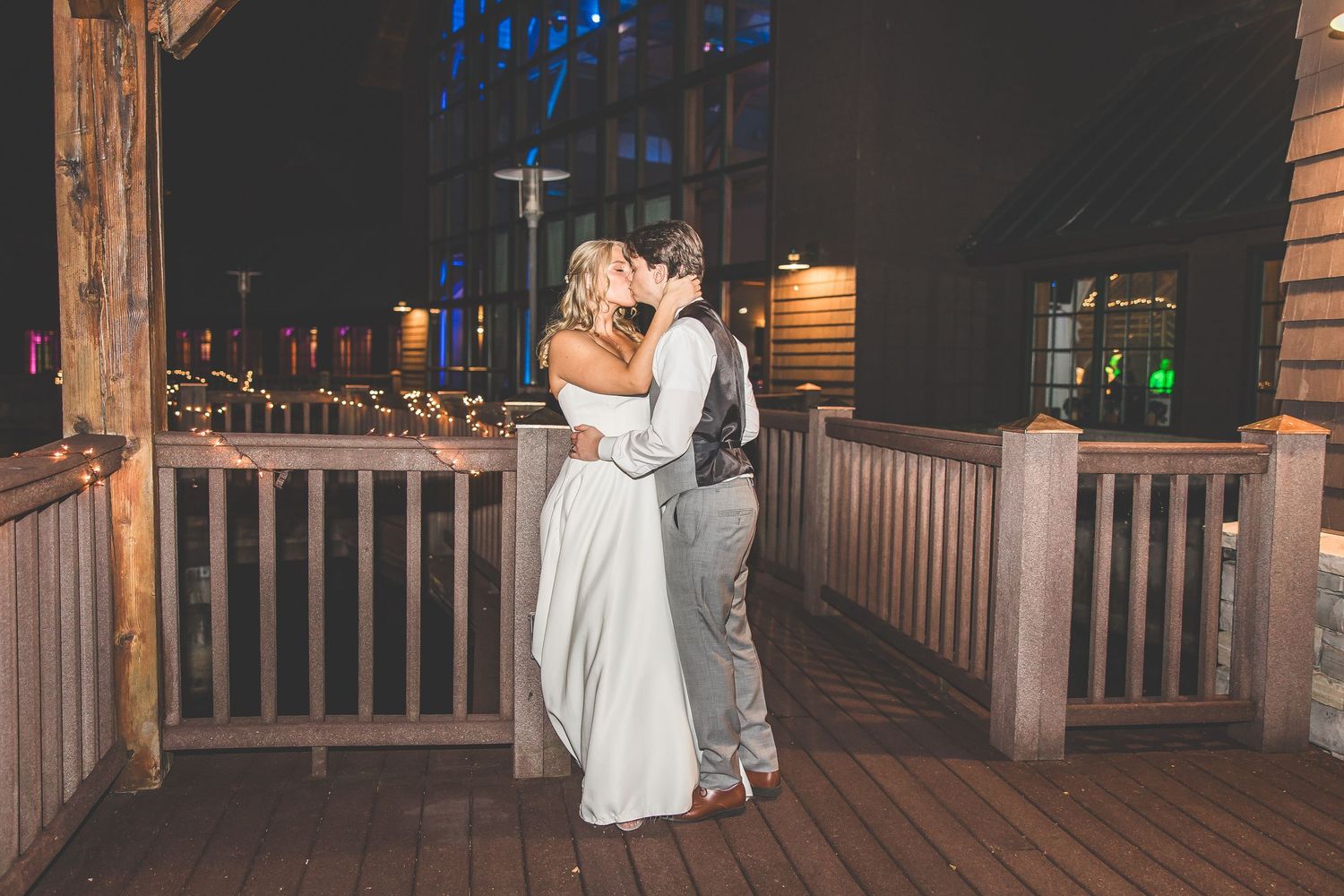 Wedding venue deck illuminated at night with blue accent lighting.