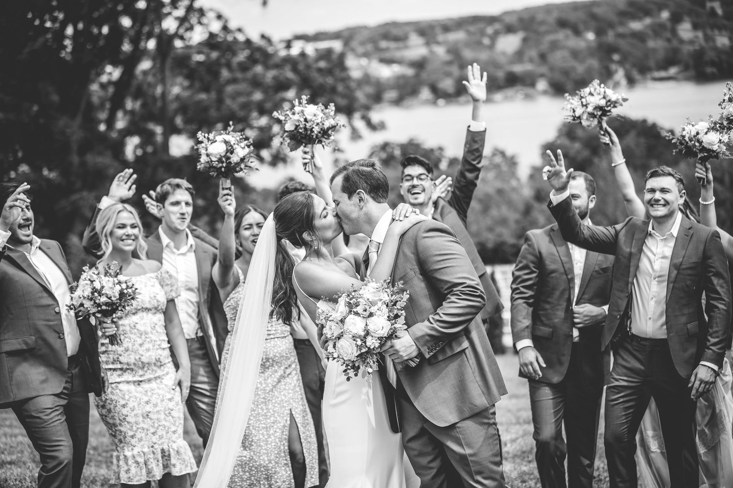 Candid celebration shots of wedding party jumping and laughing outdoors.