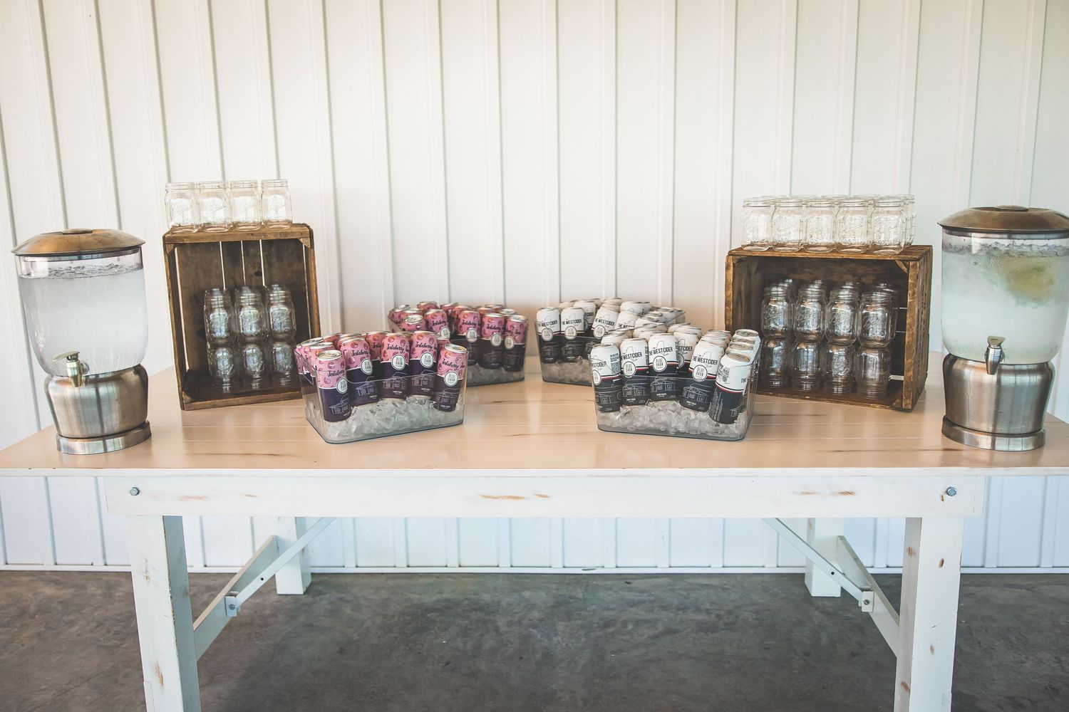White wooden reception table display with vintage decor and party favors.