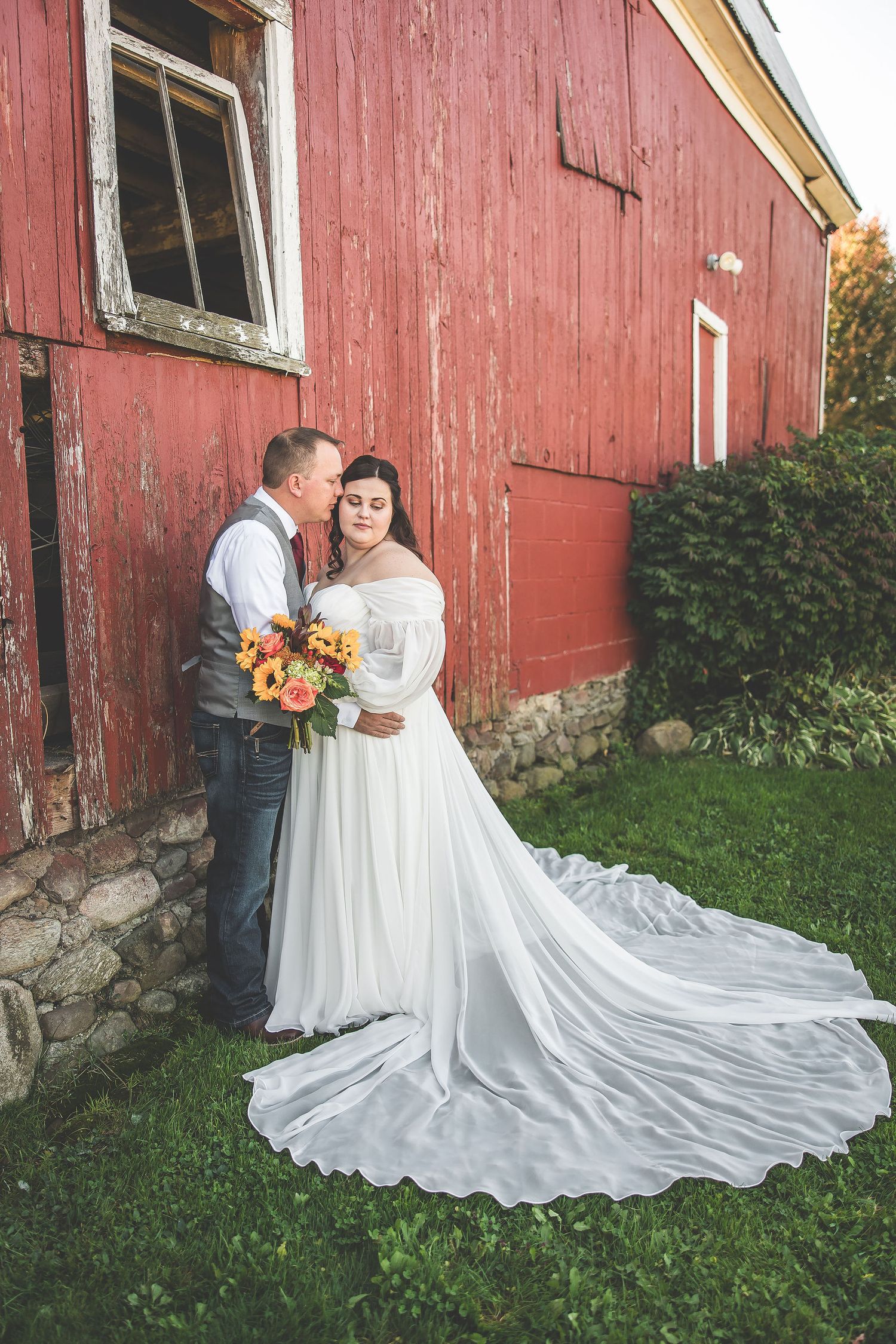 Romantic wedding portraits featuring rustic barn and autumn bouquet.
