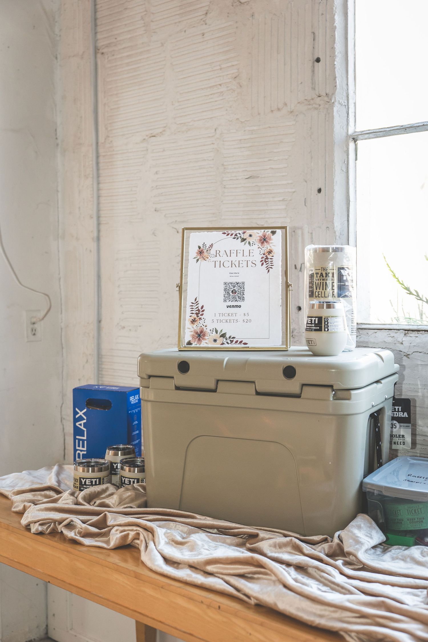 White industrial space with coolers and supplies set up for event preparation.