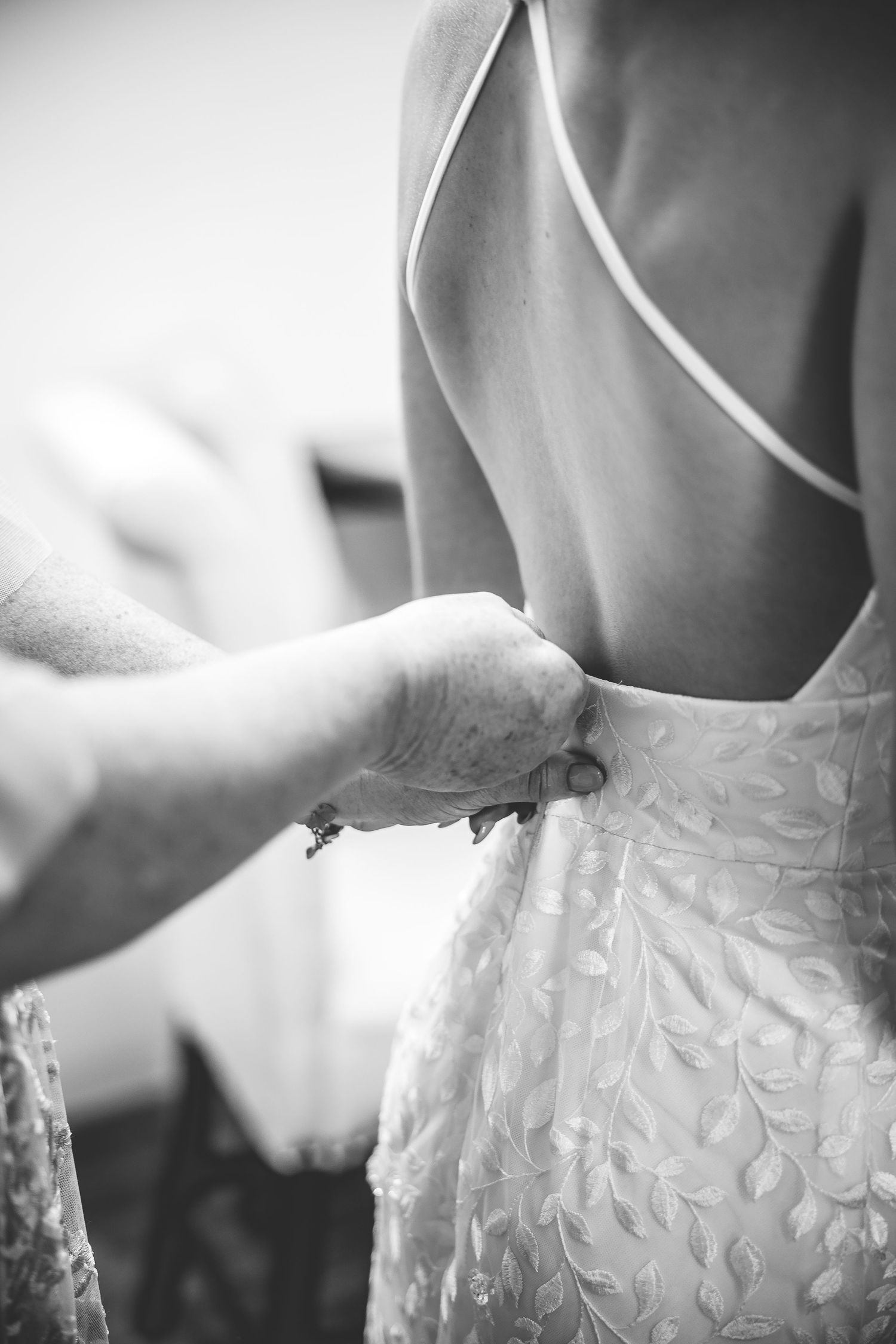Close-up detail shots of an intricate white lace wedding dress pattern.
