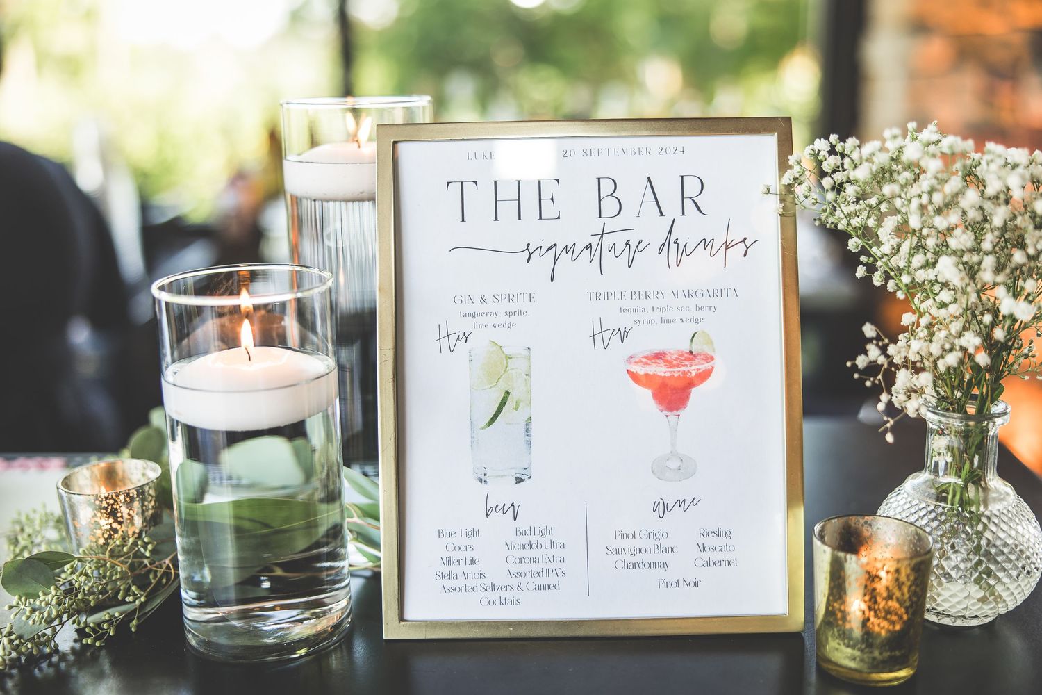 Wedding reception details including bar menu signs and delicate floral arrangements.