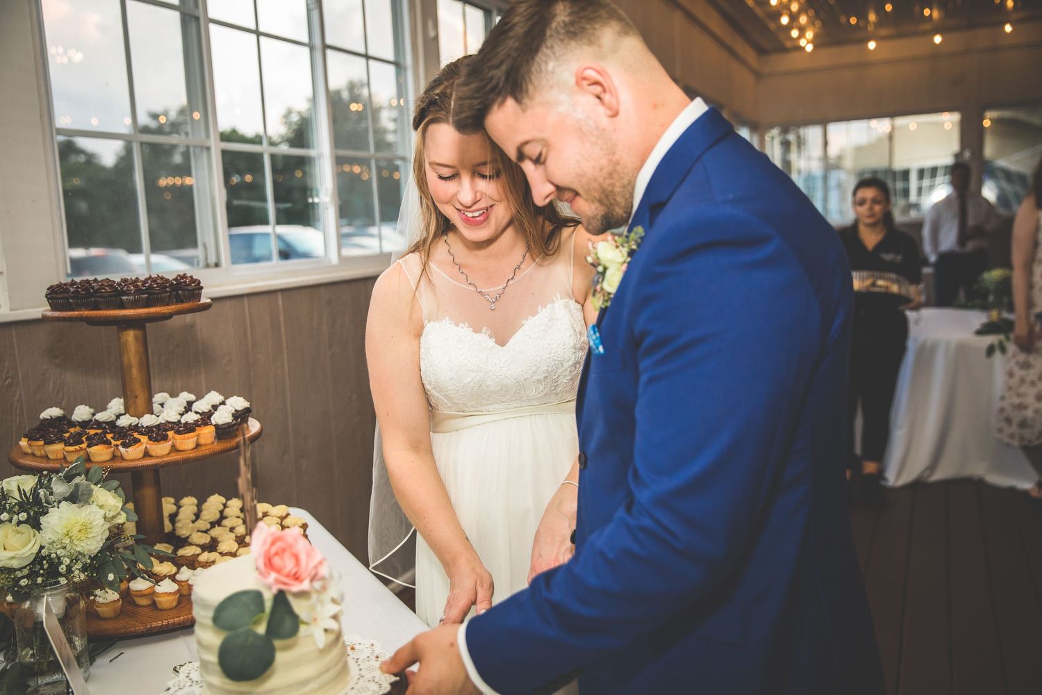 Indoor wedding reception with string lights and romantic atmosphere.