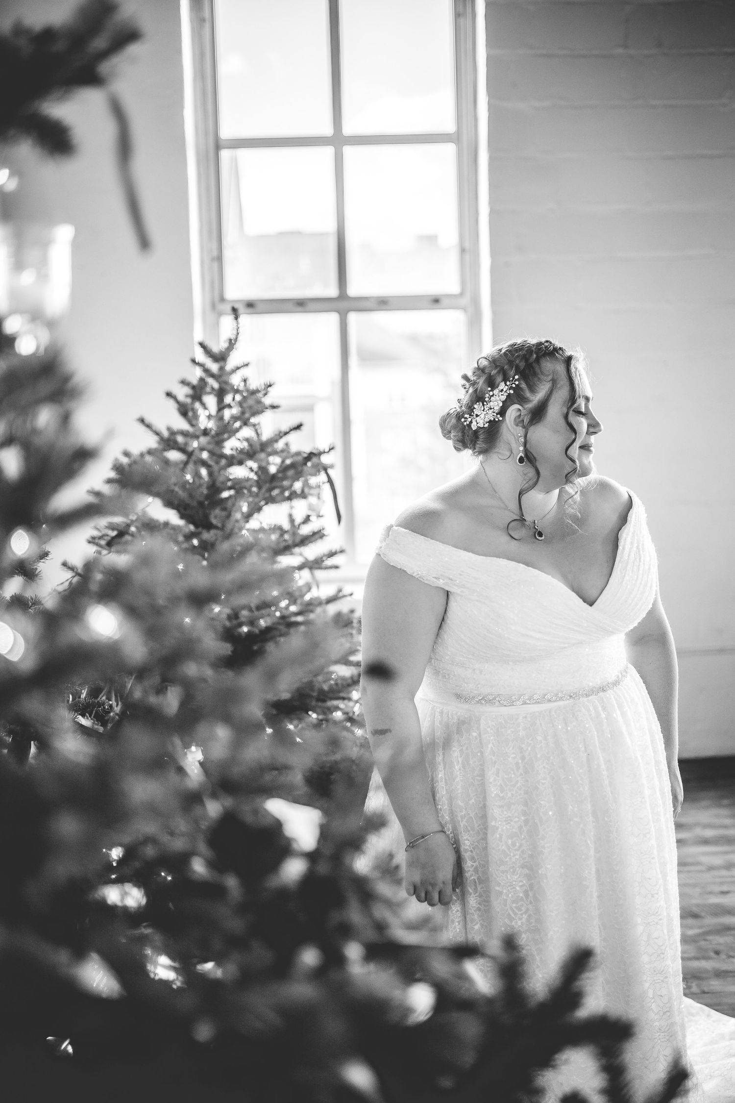 Black and white bridal portraits with Christmas trees creating a winter atmosphere.