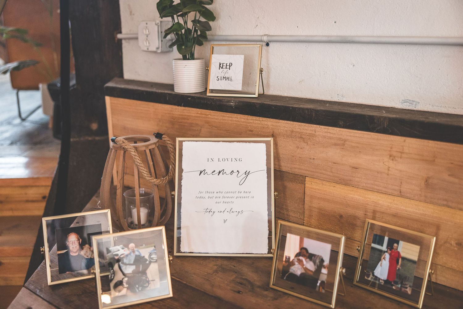 Wedding venue interior with framed photographs displayed along wooden paneled walls.
