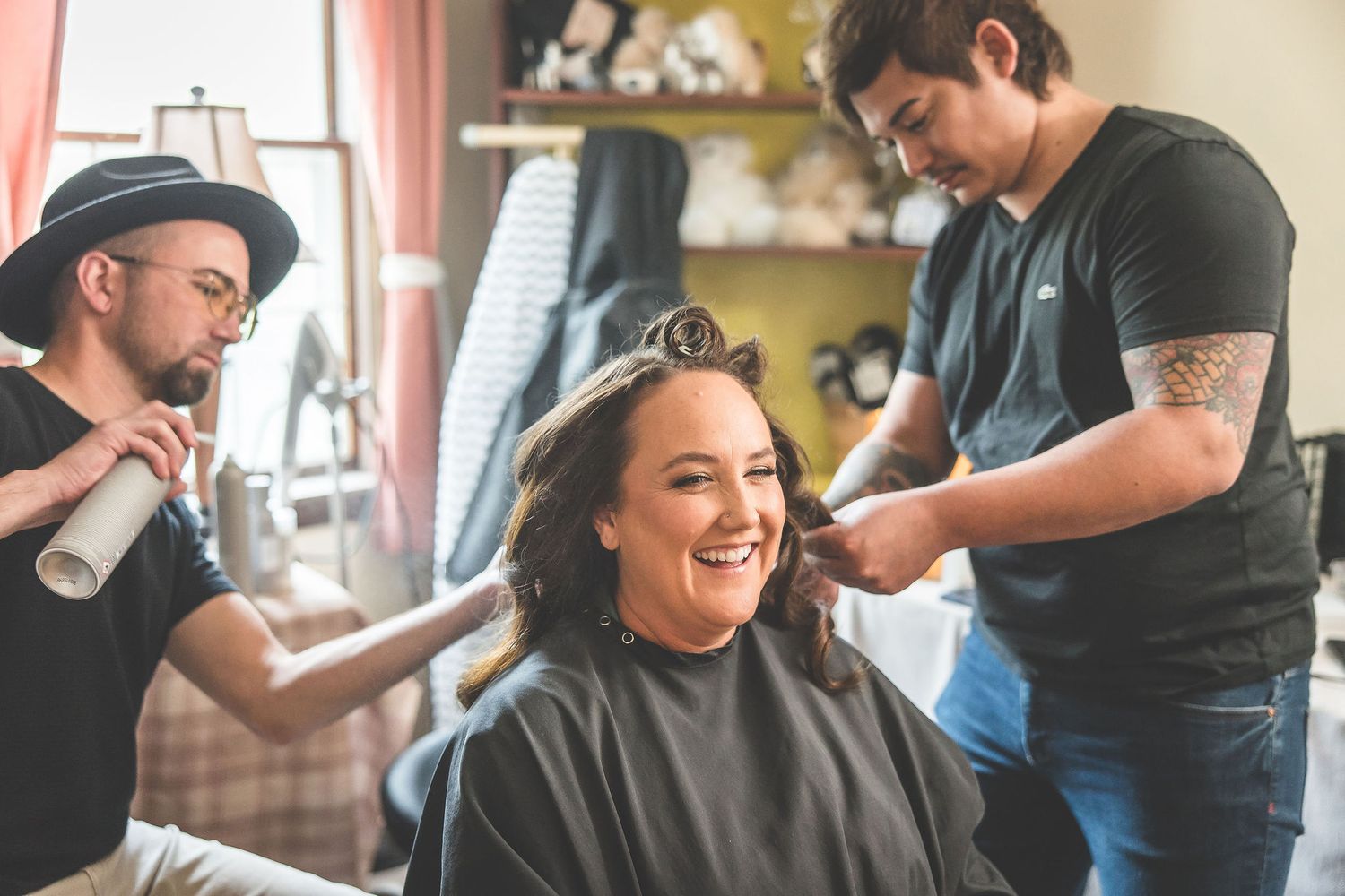 A joyful moment captured during wedding day preparations in a home setting.