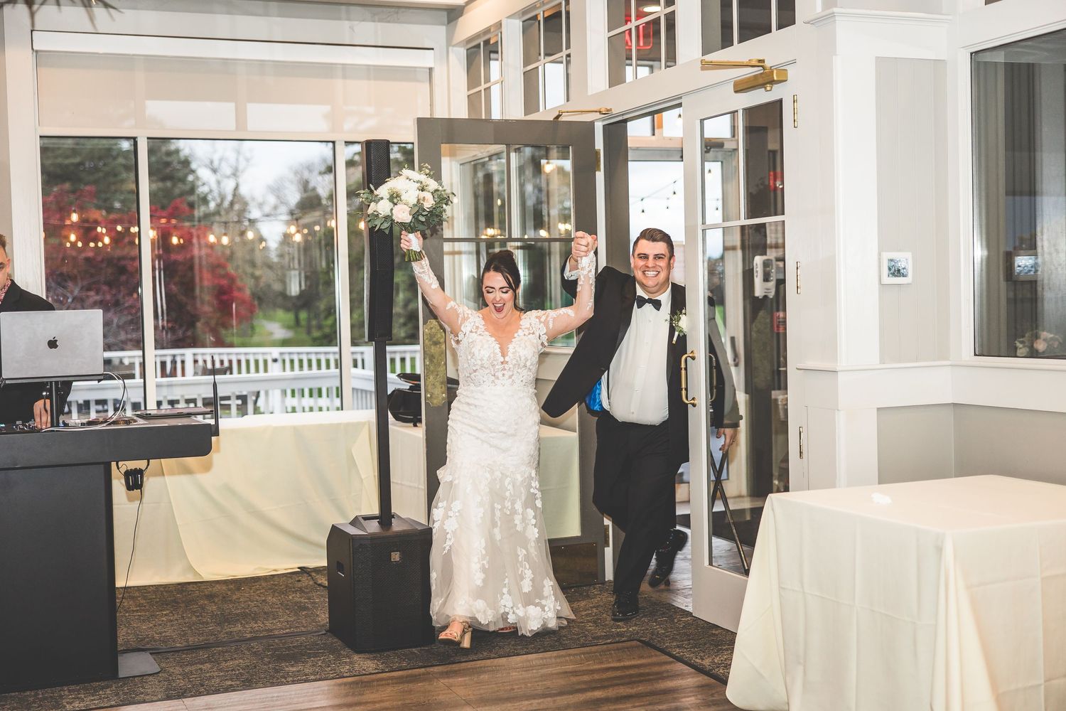 Modern wedding venue interior with large windows and white decor.