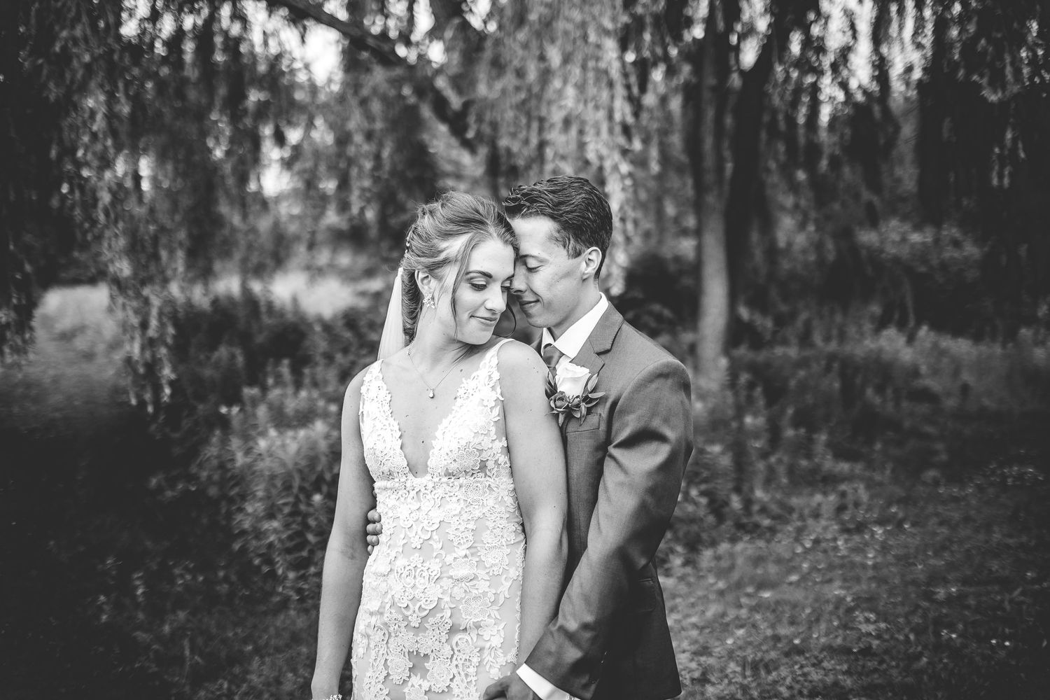 Black and white wedding portraits capturing romantic moments between the newlyweds.
