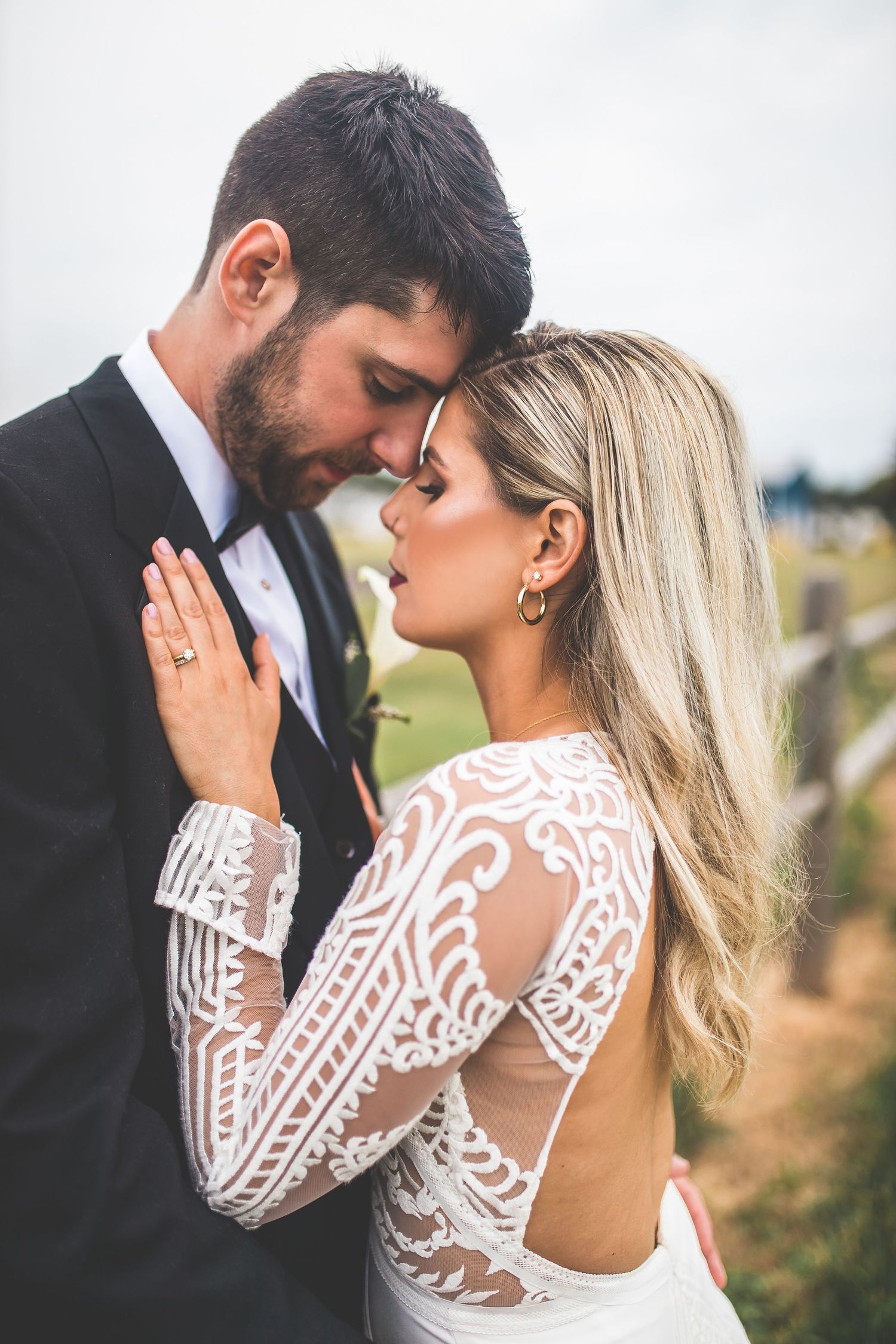 Romantic wedding portraits showing lace dress details in natural light.