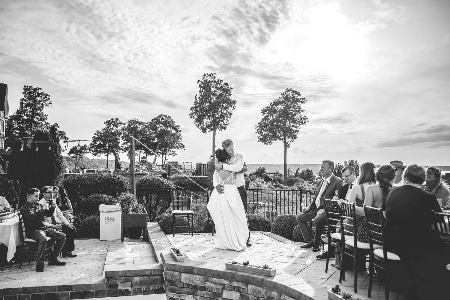 Black and white photos capture outdoor wedding ceremony moments at sunset.
