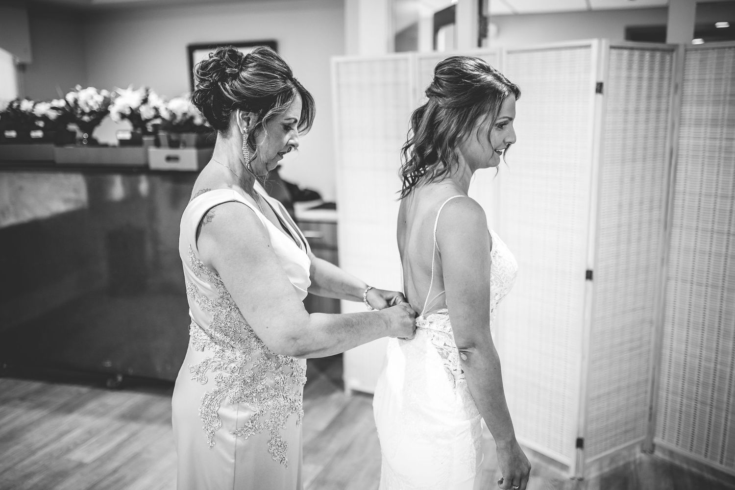 Wedding preparation moments captured in black and white photography.