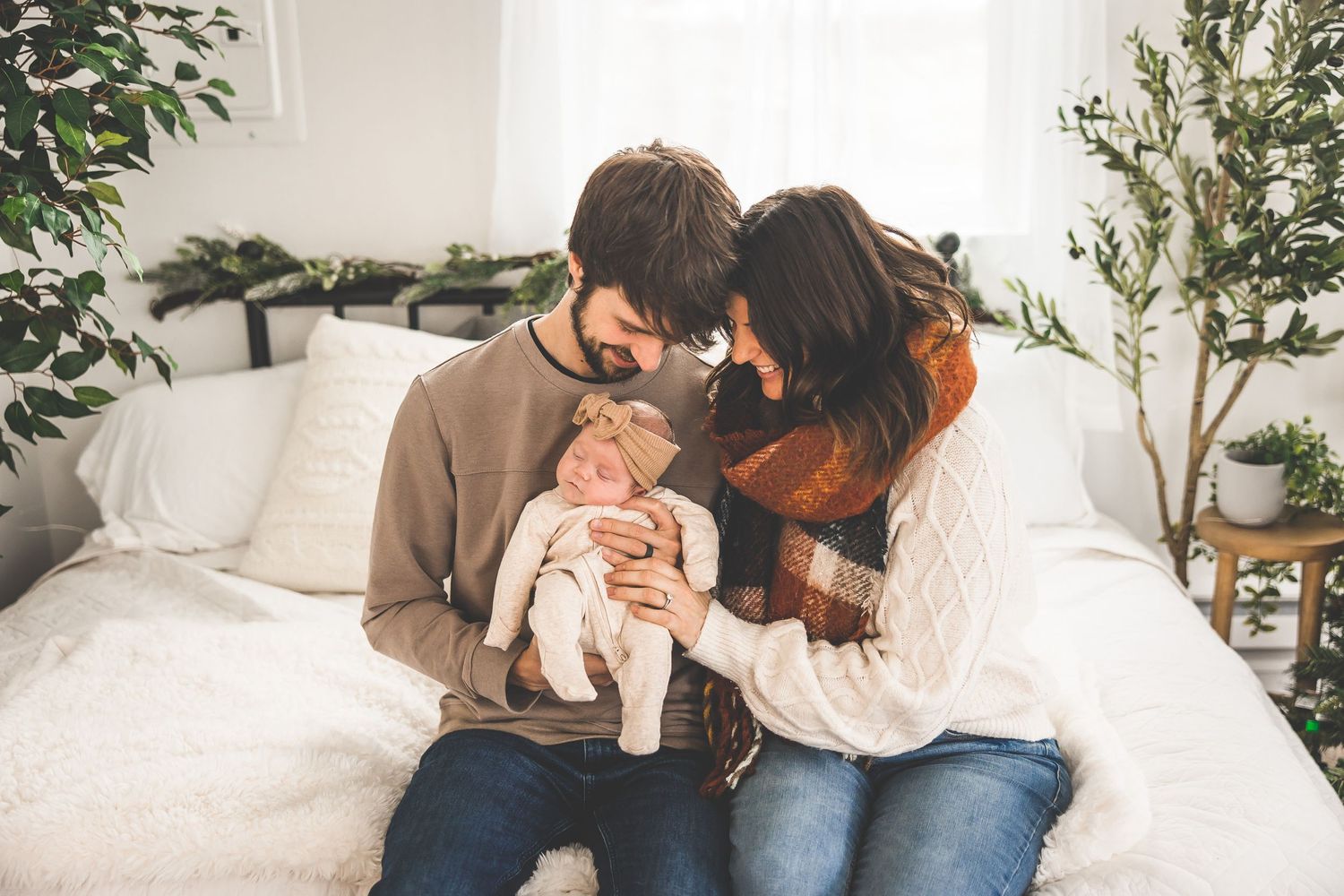 Family lifestyle photography session in bright white room with indoor plants.