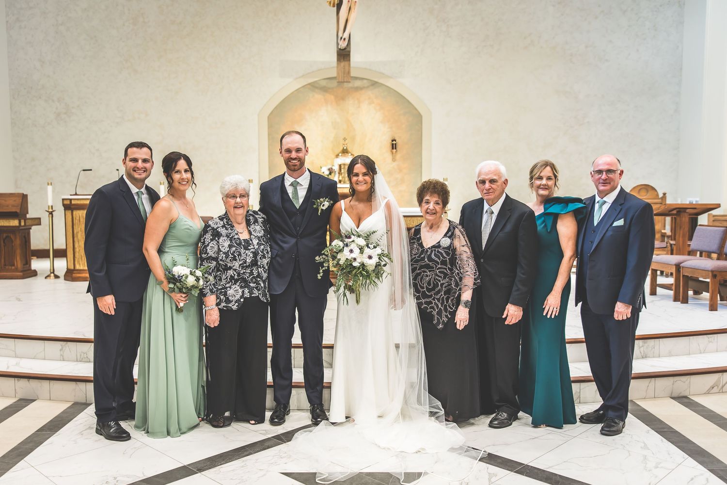 Wedding party group photos arranged in front of a church altar with formal attire.