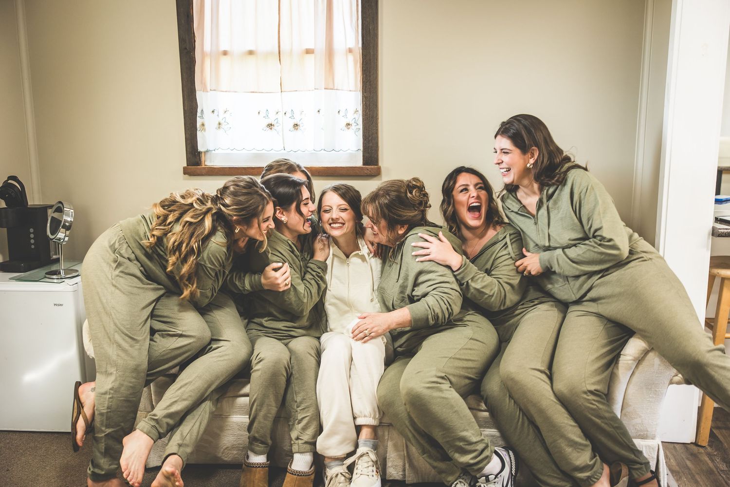Candid group moment showing joyful celebration in matching outfits.