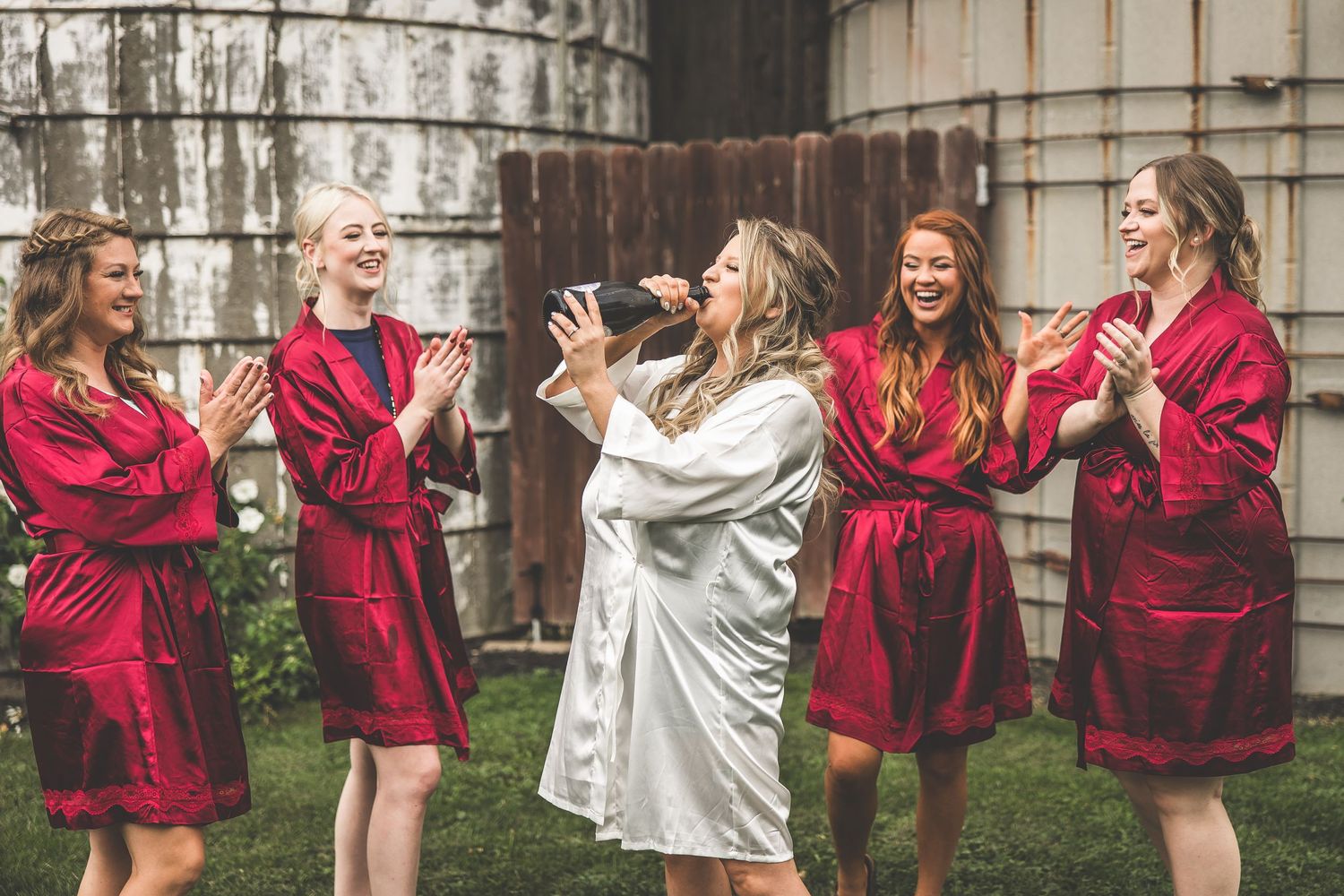 Celebratory moment with champagne spray in a garden setting.