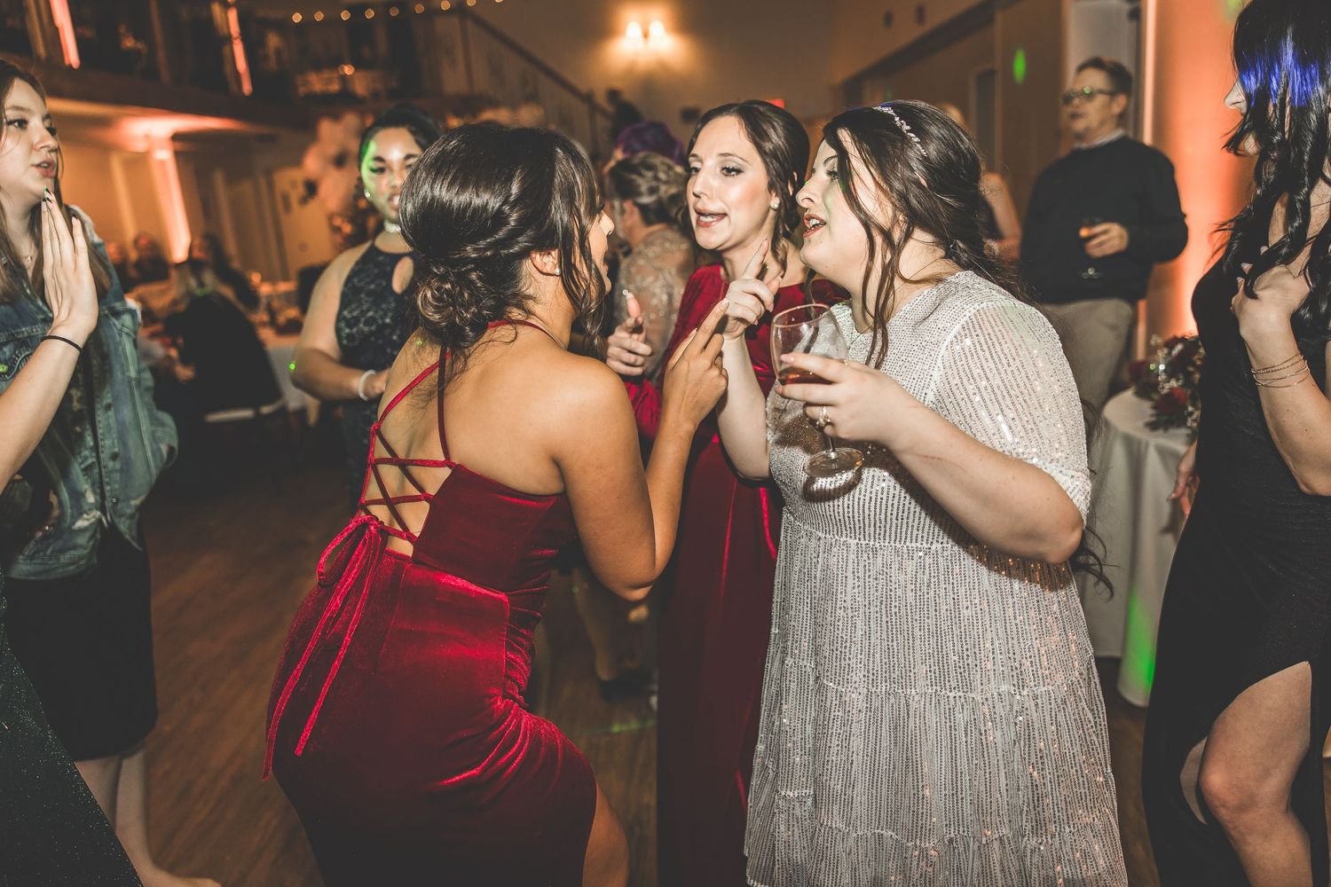 Lively dance floor scene with guests in formal wear at evening reception.