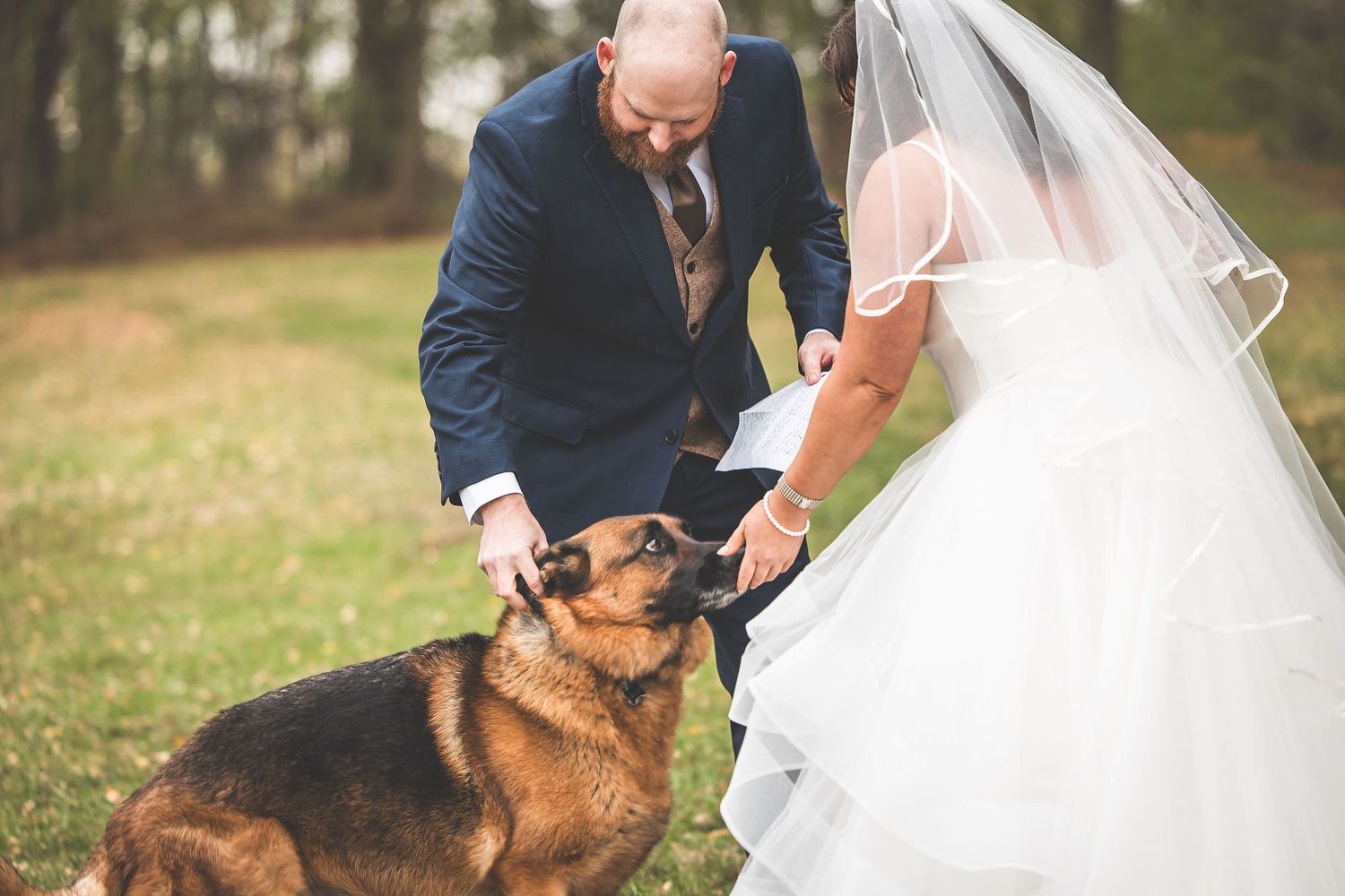 A German Shepherd dog joins the couple during their wedding ceremony.