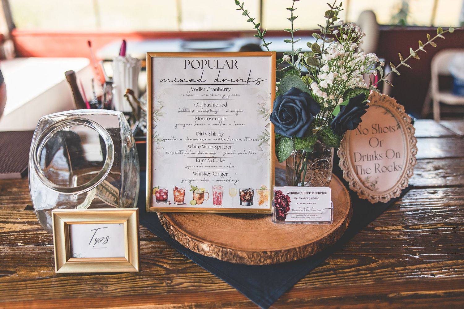 Wedding signage and decorative details displayed on rustic wooden surfaces.