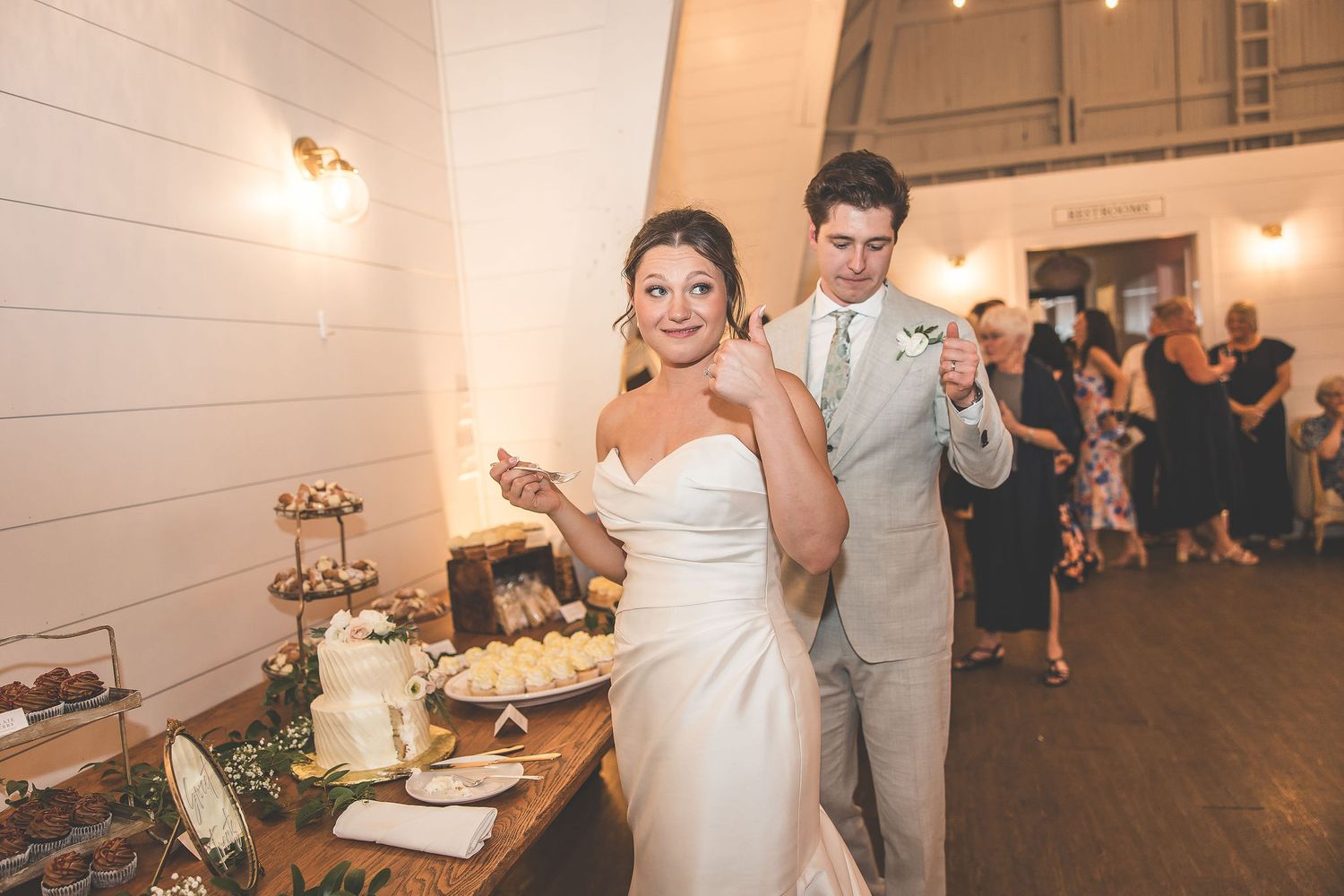 Traditional wedding cake feeding moment captured during reception celebrations.