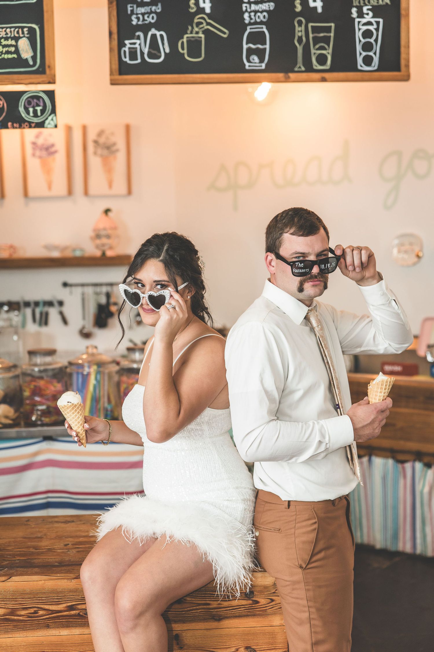 Fun ice cream shop photoshoot with vintage decor and chalkboard menu in background.