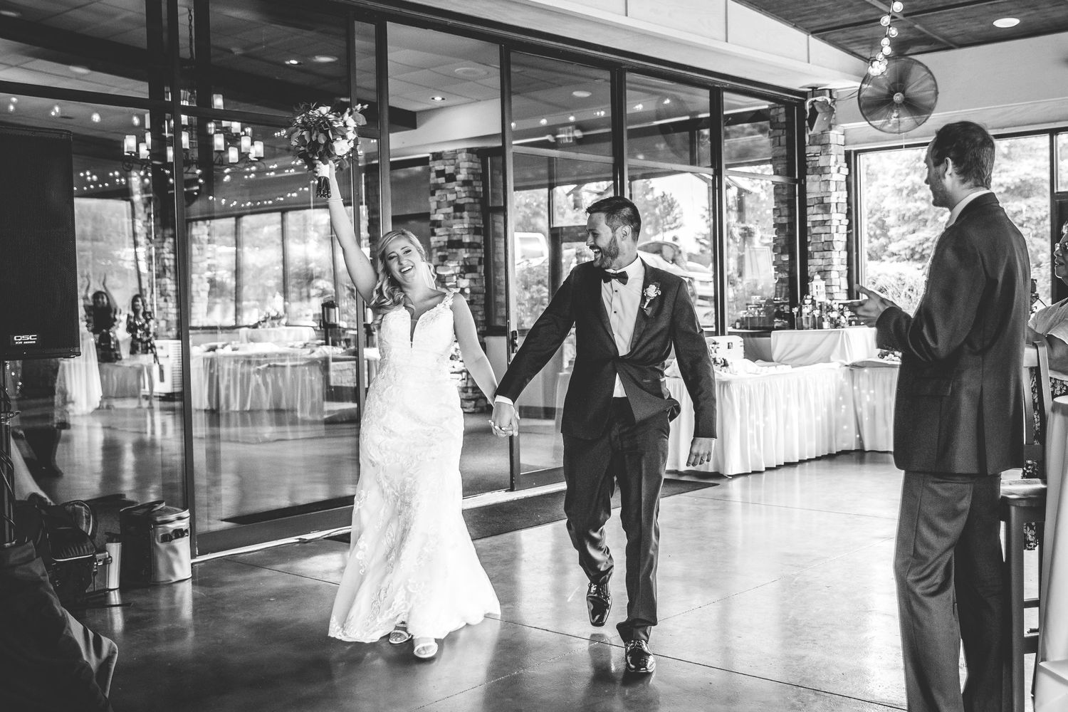 A couple makes their grand entrance into their wedding reception hall.