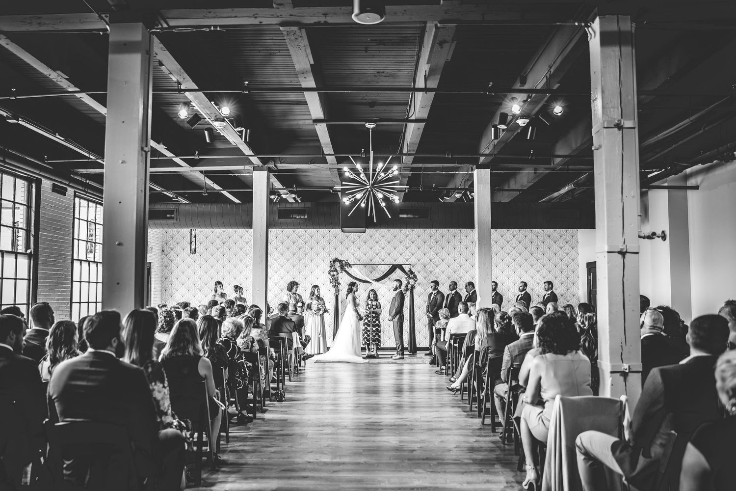 Industrial venue space set up with chairs for a wedding ceremony.