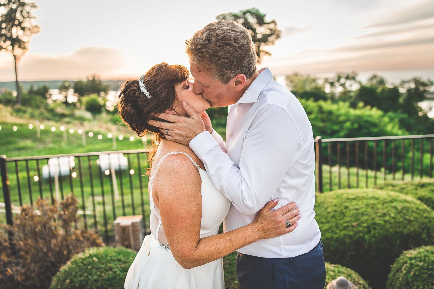 Romantic wedding couple sharing tender moments during golden hour photo session.