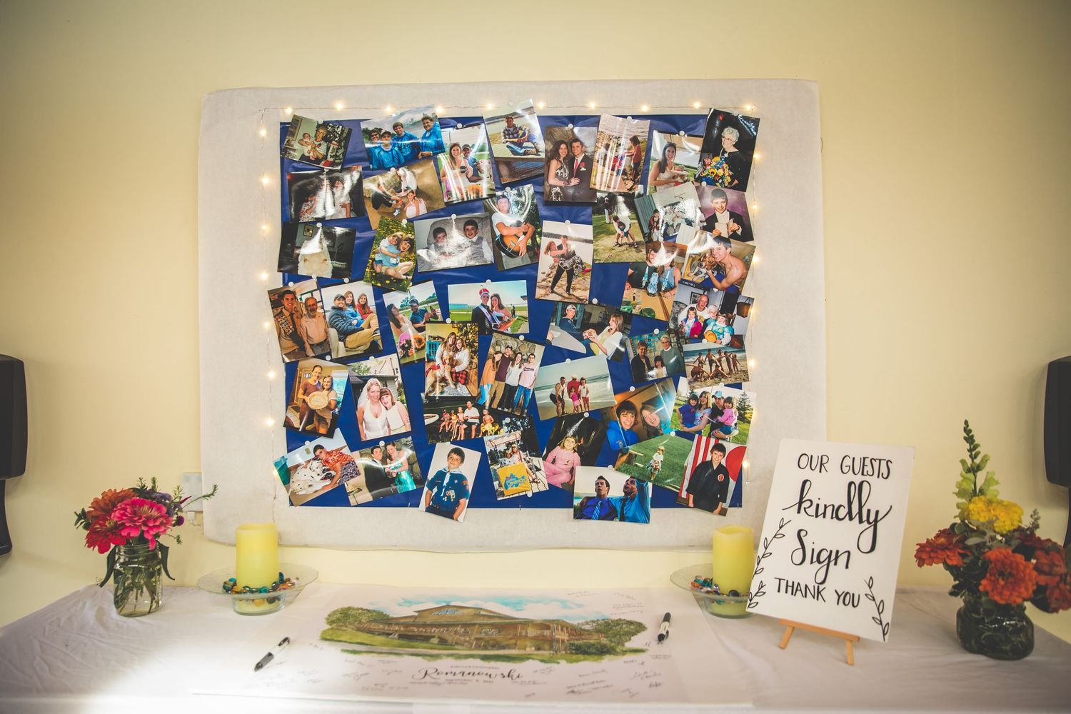 A photo collage display with colorful pictures and decorative elements on a wall.