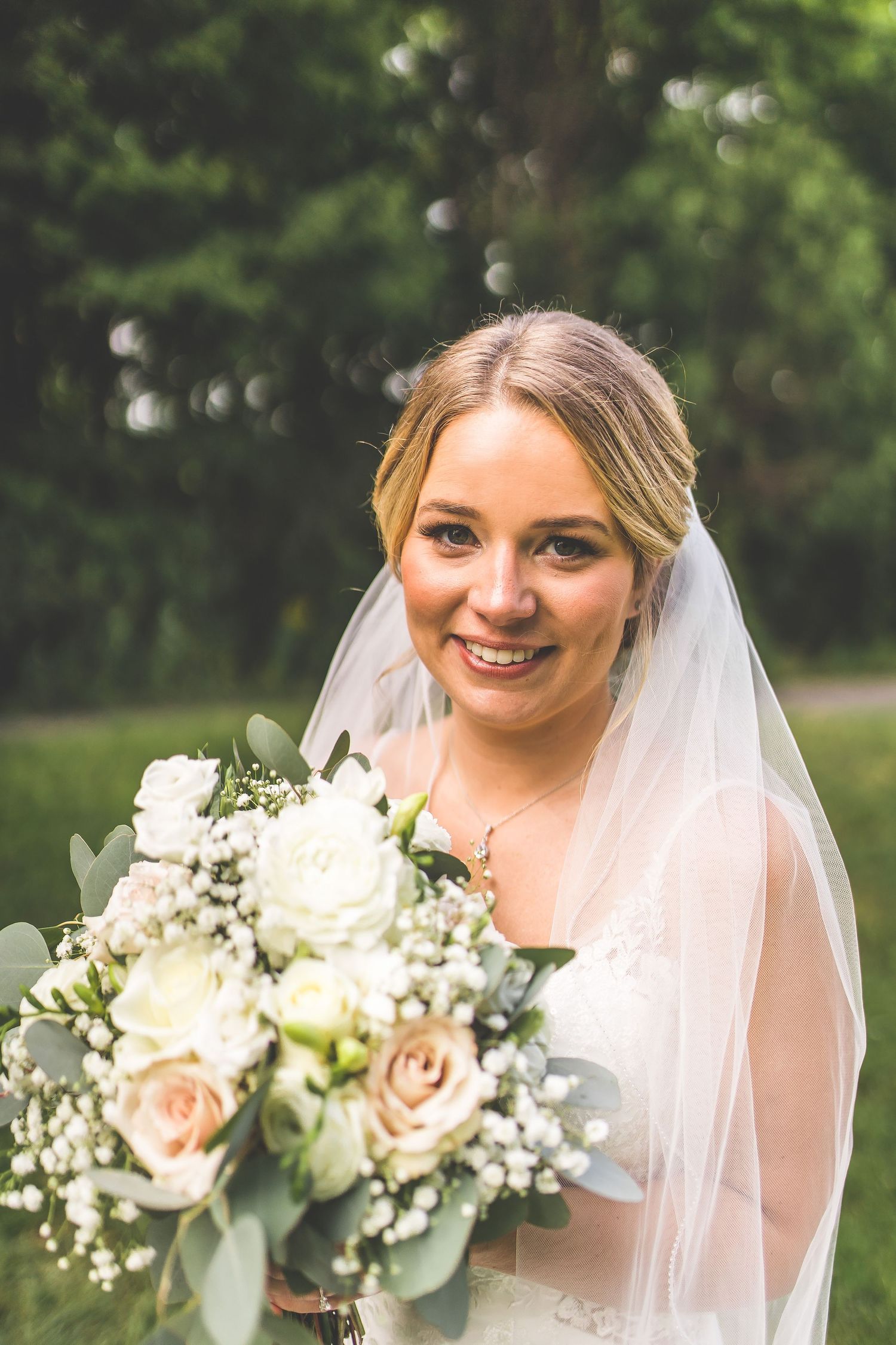 Close-up wedding portraits with white and blush rose bouquet details.