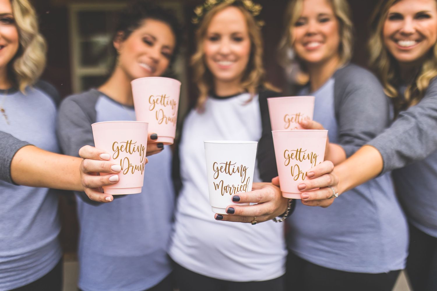 Row of matching gray t-shirts with custom text being worn by wedding party.