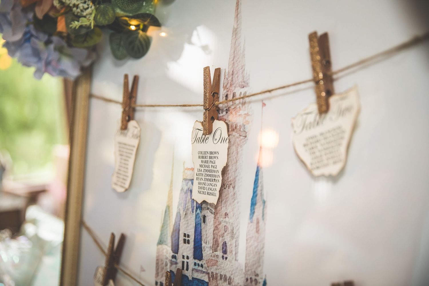 Vintage photos and notes hang from a rustic string with wooden clothespins.