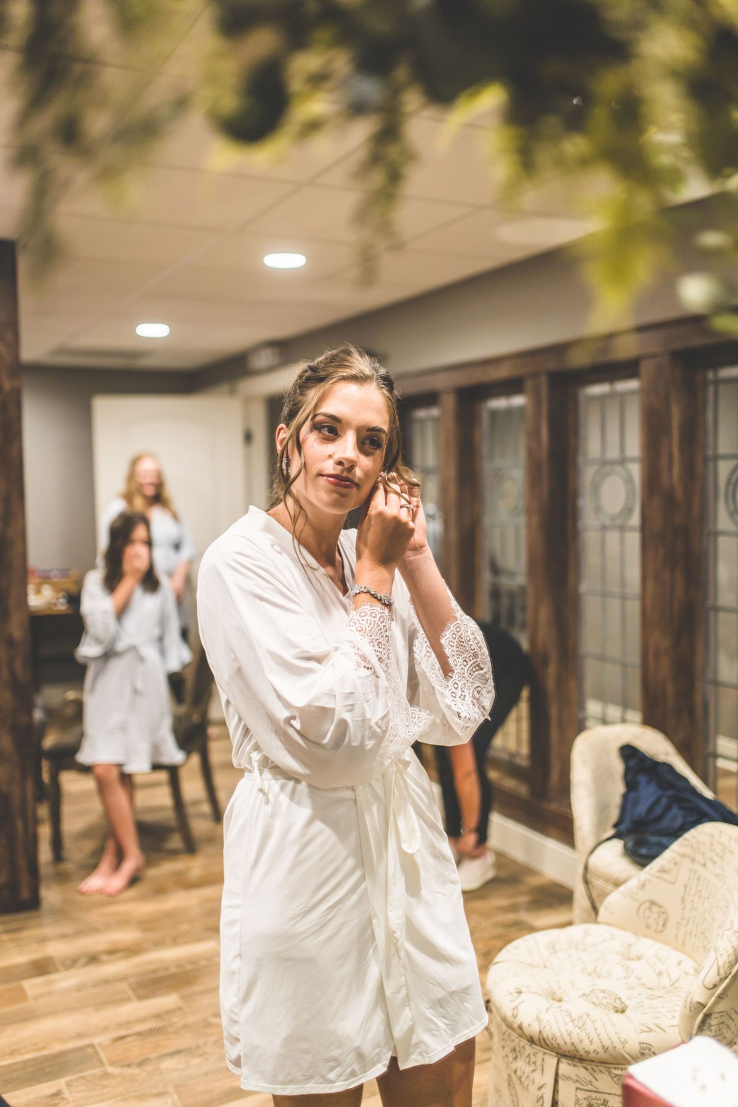 Getting ready scene with white robes and natural window lighting.
