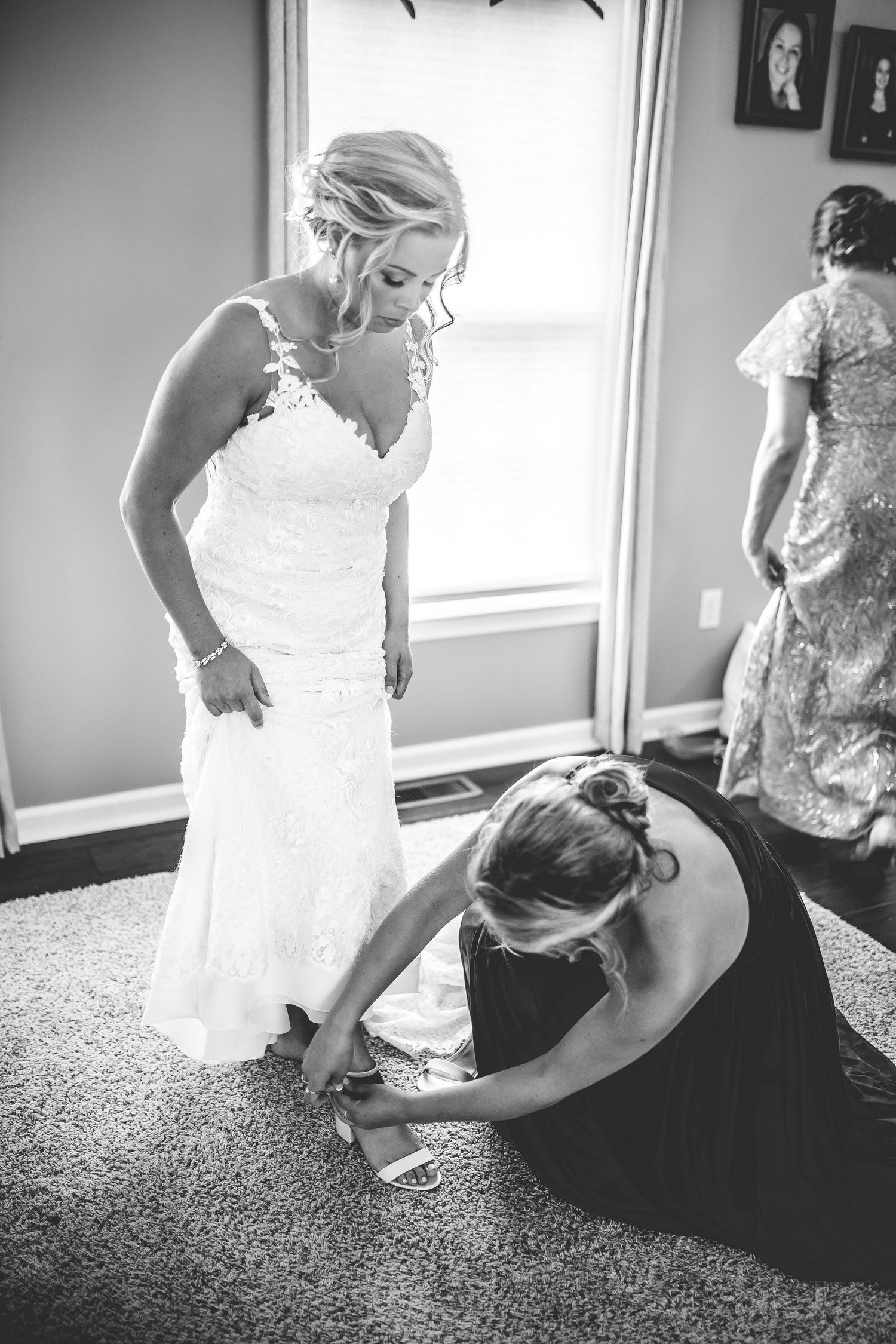 Black and white photos showing wedding dress fitting and preparation moments.