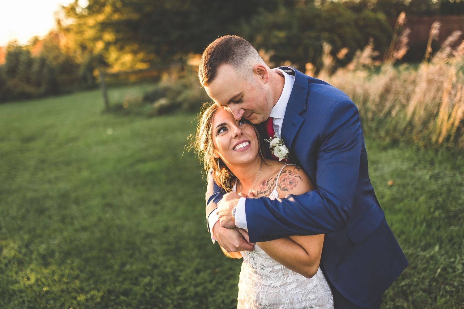 Playful moment between couple during golden hour wedding photoshoot.