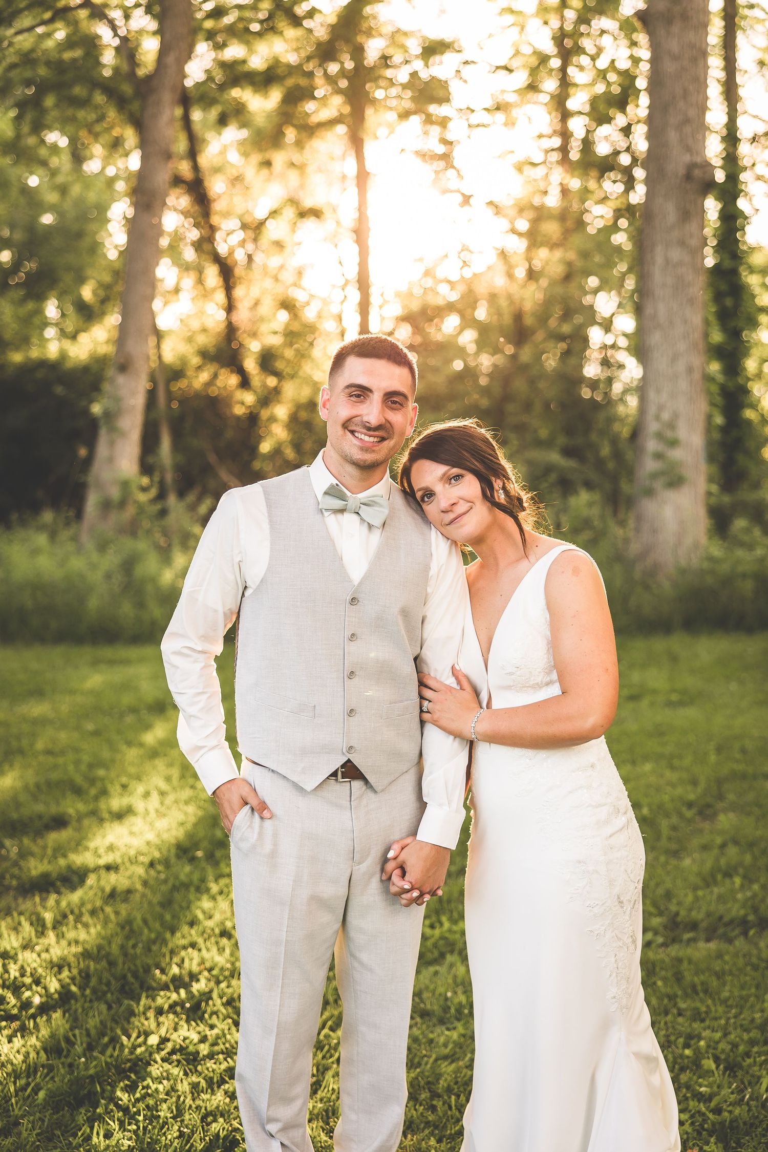 A romantic sunset photo session in a wooded area with golden light filtering through trees.