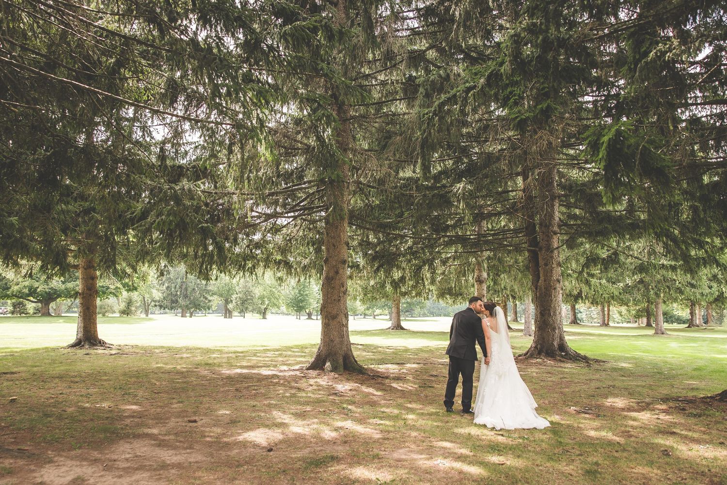 Series of wedding couple portraits taken in a serene wooded setting.