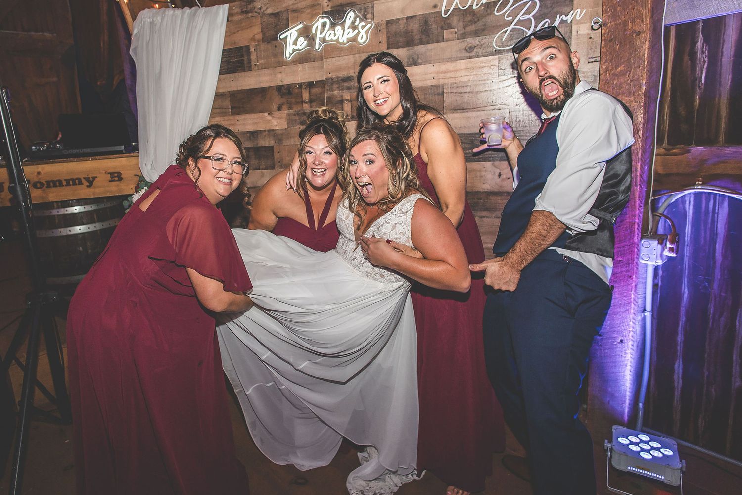 Guests celebrating on the dance floor at a rustic barn wedding venue.