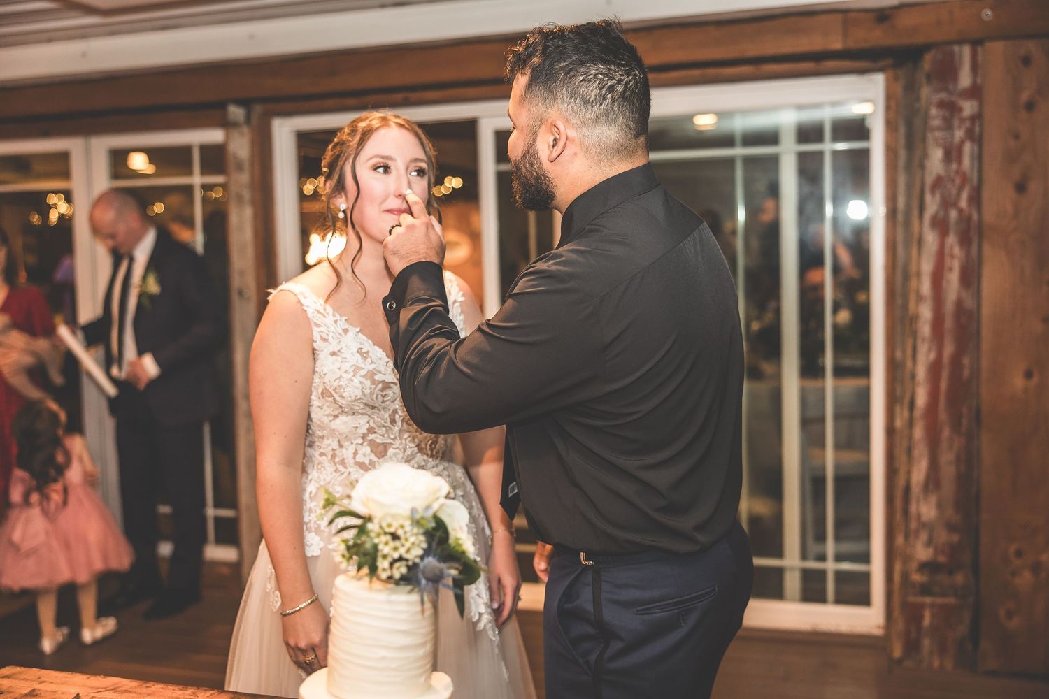 Reception venue with elegant wood paneling and warm lighting for an indoor celebration.
